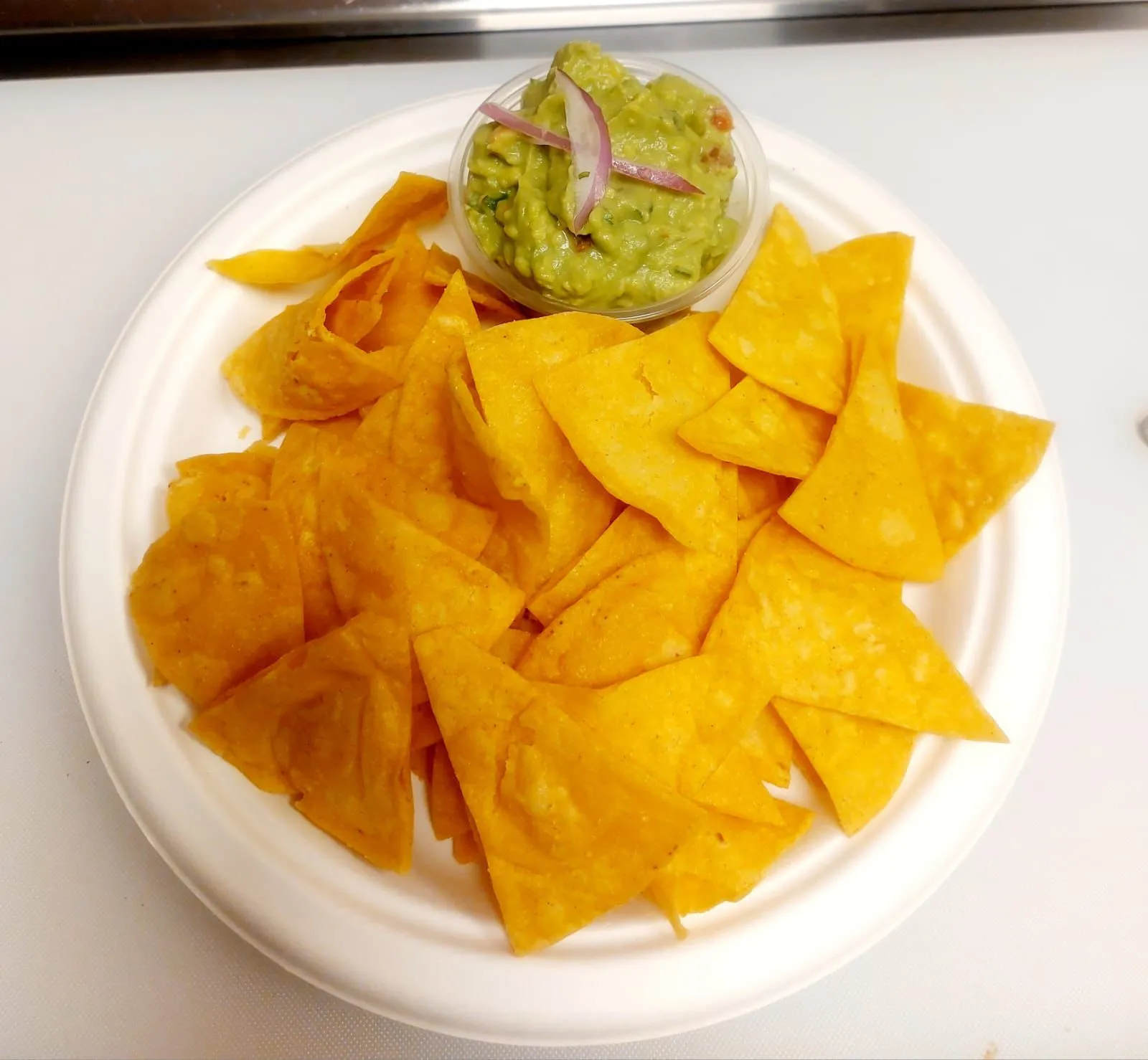 Homemade tortilla chips with guacamole and pico de gallo at PiKanté Edmonton